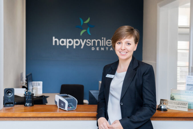Receptionist from Happy Smiles smiling into the camera.