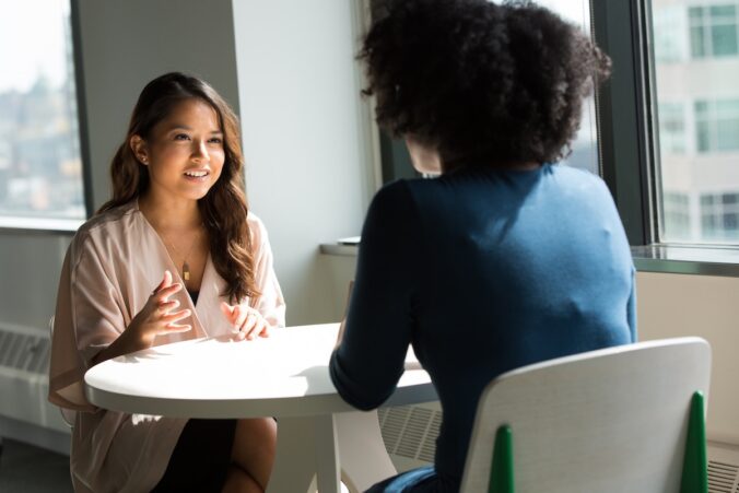 Two female employees talking.