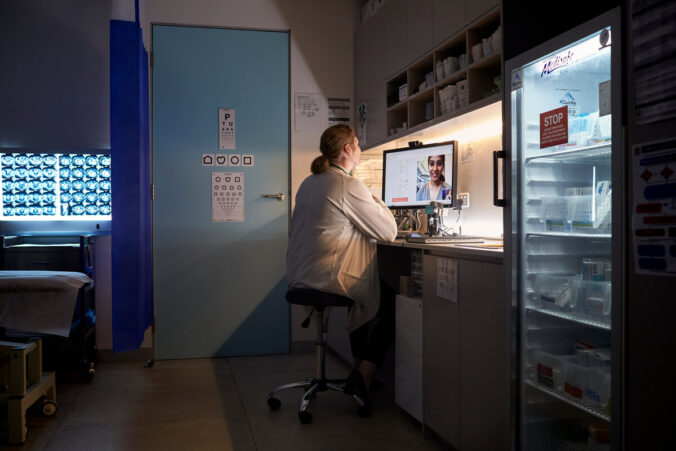 A doctor having a telehealth consultation on their computer with a patient.