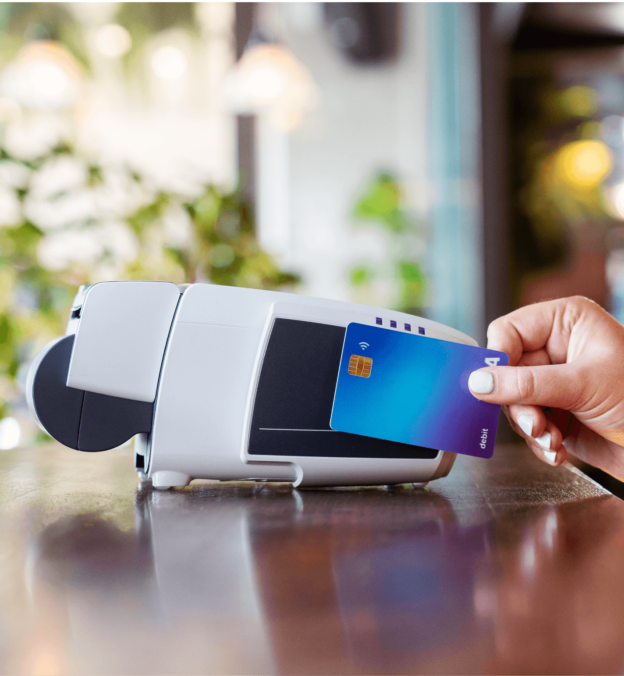 Person tapping a debit card against a Tyro CounterTop EFTPOS terminal.