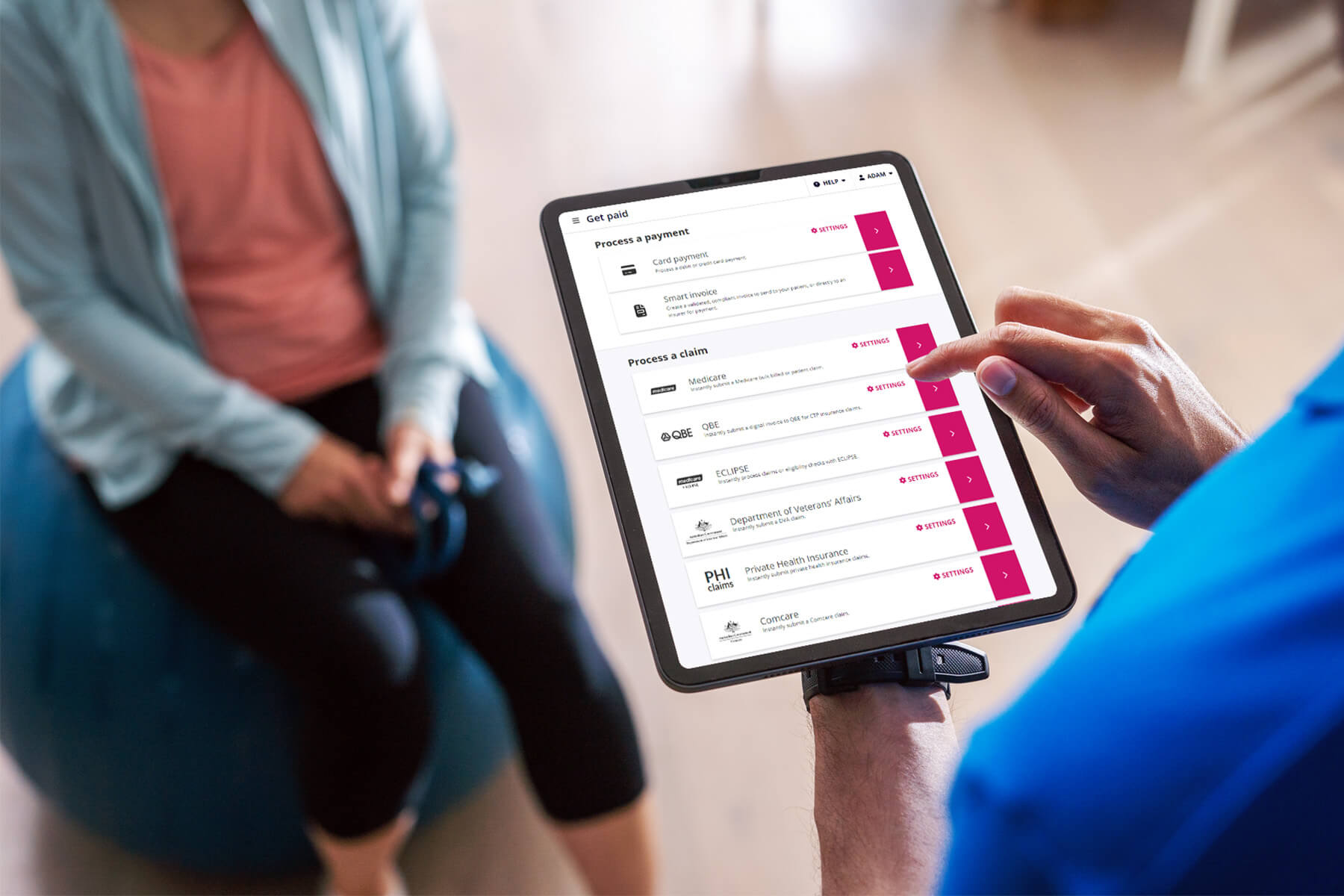 A finger on an iPad screen to select a Tyro Health Online menu item.