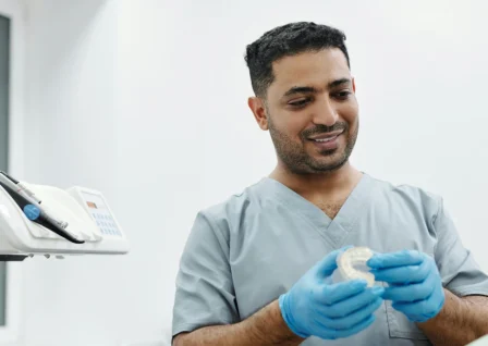 Healthcare provider examining dental device, aligned with faster settlement for practices.